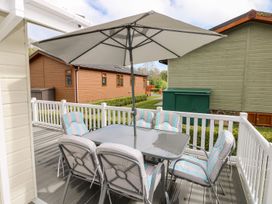 An outdoor dining area with a table and chairs at Erisa 
