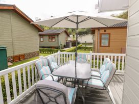 An outdoor patio with a table and chairs under an umbrella at Erisa
