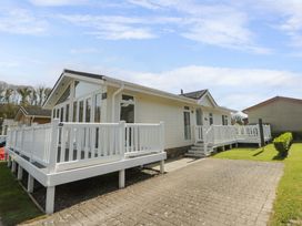 A house with a deck and yard at Erisa in Stepaside