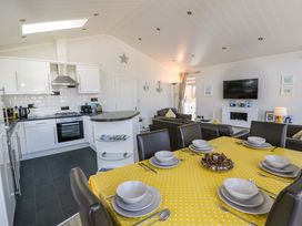 An open plan living area with a kitchen and dining table at Erisa in Stepaside