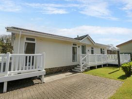A house with a deck and driveway at Erisa in Stepaside