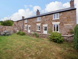 A house with a garden and seating area at Isfryn