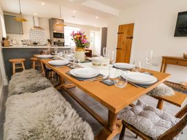 A dining room with a table set for meals at Isfryn