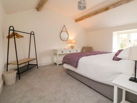 A bedroom with a bed and wardrobe rack at Isfryn