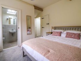 A bedroom with a bed and an ensuite bathroom at Isfryn