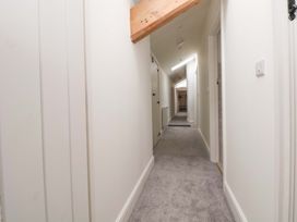 A hallway with doors and lighting at Isfryn 