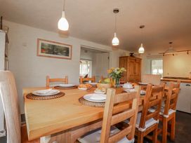 A dining room with a wooden table and chairs at Poldue House Watergate near Camelford