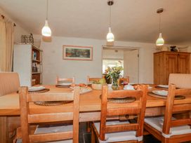 A dining room with a wooden table and chairs at Poldue House Watergate near Camelford