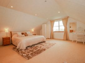 A bedroom with a bed and dressing table at Poldue House Watergate near Camelford