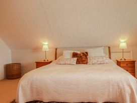 A bedroom with a bed and bedside tables at Poldue House near Watergate near Camelford