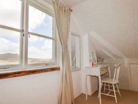 A bedroom with a desk and mirror at Poldue House Watergate near Camelford