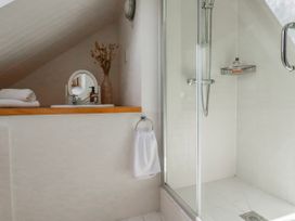 A bathroom with a shower and sink at Poldue House in Watergate near Camelford
