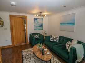 A living room with sofas and a coffee table at 2 Court Cottage in Dartmouth
