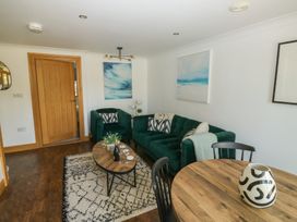 A living room with a sofa and coffee table at 2 Court Cottage in Dartmouth