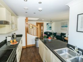 A kitchen with a stove and sink at 2 Court Cottage Dartmouth