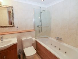 A bathroom with a sink, toilet, shower, and bathtub at 2 Court Cottage Dartmouth