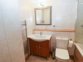 A bathroom with sink, toilet, and shower at 2 Court Cottage Dartmouth