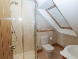 A bathroom with a shower, toilet and sink at 2 Court Cottage Dartmouth