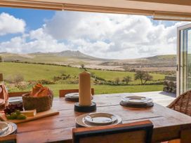 A dining table with plates and bread at Roughtor Barn Poldue near Camelford