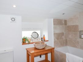 A bathroom featuring a wash basin, toilet, and bathtub at Roughtor Barn Poldue near Camelford
