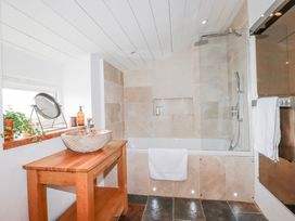 A bathroom with a bathtub and sink at Roughtor Barn Poldue near Camelford