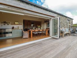 A kitchen with a dining area and outdoor seating at Roughtor Barn Poldue near Camelford