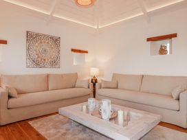 A living room with sofas and a coffee table at Logan Barn in Poldue near Camelford