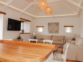 A living room with a sofa and television at Logan Barn near Camelford