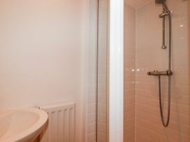 A bathroom featuring a sink and a shower at Logan Barn in Poldue near Camelford