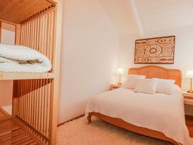 A bedroom with a bed and shelf at Logan Barn in Poldue near Camelford