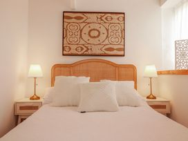 A bedroom with a bed and bedside tables at Logan Barn near Poldue near Camelford