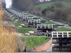 A view of a canal with locks and a path at The West Wing in Potterne