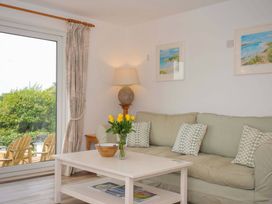 A living room with a couch and a coffee table at Seaworthy in Daymer Bay
