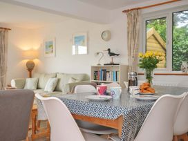 A dining room with a table and chairs at Seaworthy in Daymer Bay