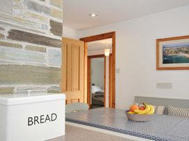 A kitchen with a bread box and fruit bowl at Seaworthy in Daymer Bay
