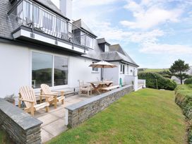 An outdoor seating area with table and chairs at Seaworthy in Daymer Bay