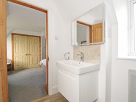 A bathroom with a sink and mirror at Seaworthy in Daymer Bay