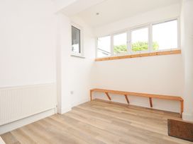 A mudroom with a bench and hooks at Seaworthy in Daymer Bay