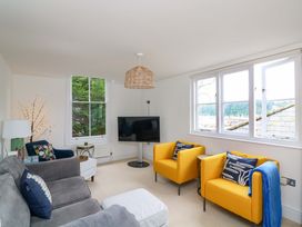A living room with a television and seating area at 2 The Old School House