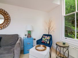 A living room with a sofa, chair, and table at 2 The Old School House 