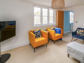 A living room with armchairs and a television at 2 The Old School House
