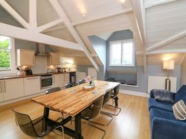 A living room with a dining table and kitchen area at 2 The Old School House