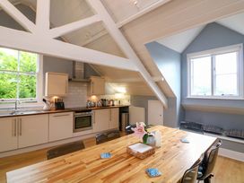A kitchen with a dining table and chairs at 2 The Old School House in 