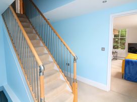 A staircase with handrail leading to a hallway at 2 The Old School House