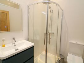 A bathroom with a shower, sink, and toilet at 2 The Old School House 