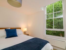 A bedroom with a bed and lamp at 2 The Old School House