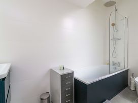 A bathroom with a bathtub and shower at 2 The Old School House