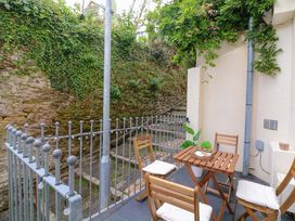 An outdoor seating area with a table and chairs at 2 The Old School House 