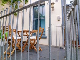 A patio area with a table and chairs at 2 The Old School House in 