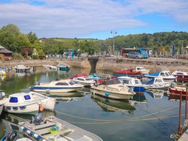 A marina with boats in water and a road at 2 The Old School House 